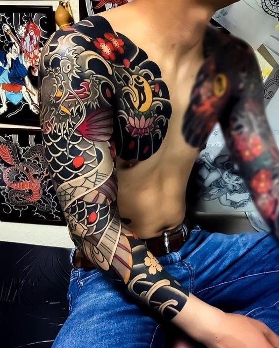 a man with many tattoos on his arm