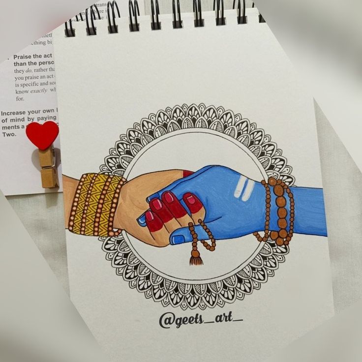 a drawing of two hands holding each other on top of a table next to a red heart