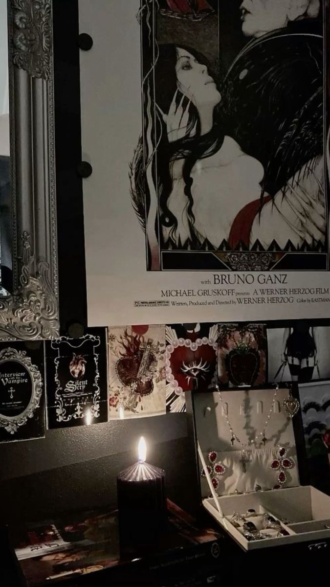 an image of a woman's face on the wall next to a mirror and jewelry box