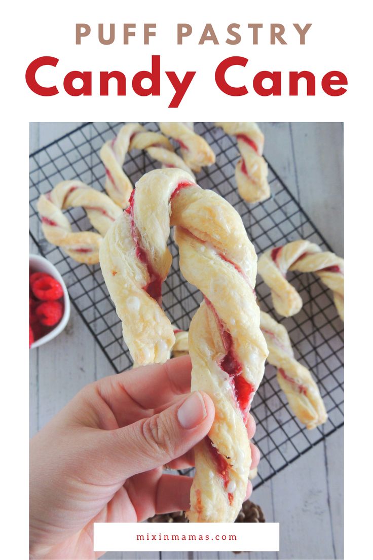 a person holding up a candy cane with the words puff pastry candy cane on it