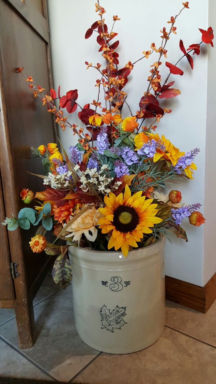 a bucket filled with lots of different types of flowers