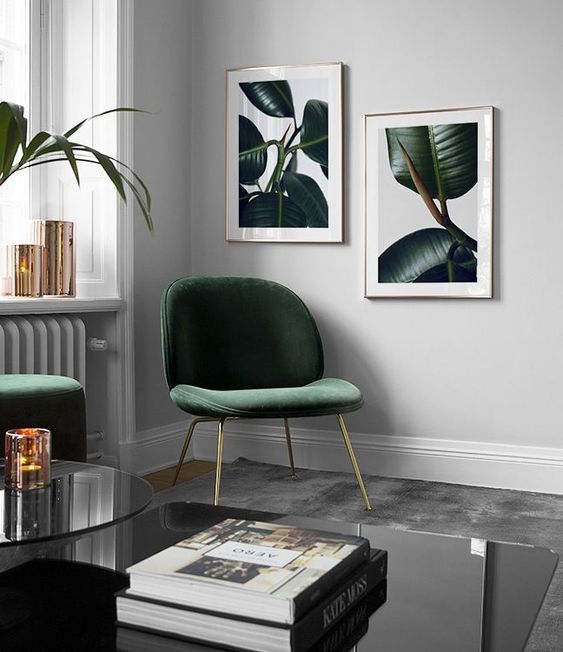 a living room with two green chairs and a coffee table