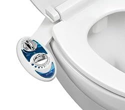 a close up of a toilet with the lid open and an electronic button on it