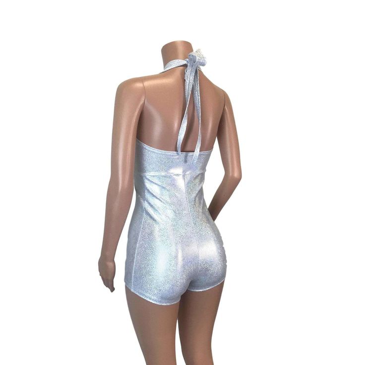 Made of our silver on white holographic spandex, this halter romper hugs the body, but offers plenty of stretch. The halter top ties at the back of the neck. Our seamless front design is extremely comfortable and prevents camel toe. Wear this to a rave, to a festival, or an aerial performance. Shiny Summer Bodysuit For Club, Summer Disco Bodysuit For Club, Stretch Disco Bodysuit For Summer, Disco Style Bodysuit For Summer Clubbing, Summer Party T-back Halter Top, Metallic Bodysuit For Summer Party, Metallic Fitted Bodysuit For Summer, Silver Fitted Sleeveless Halter Top, Metallic Fitted Sleeveless Halter Top