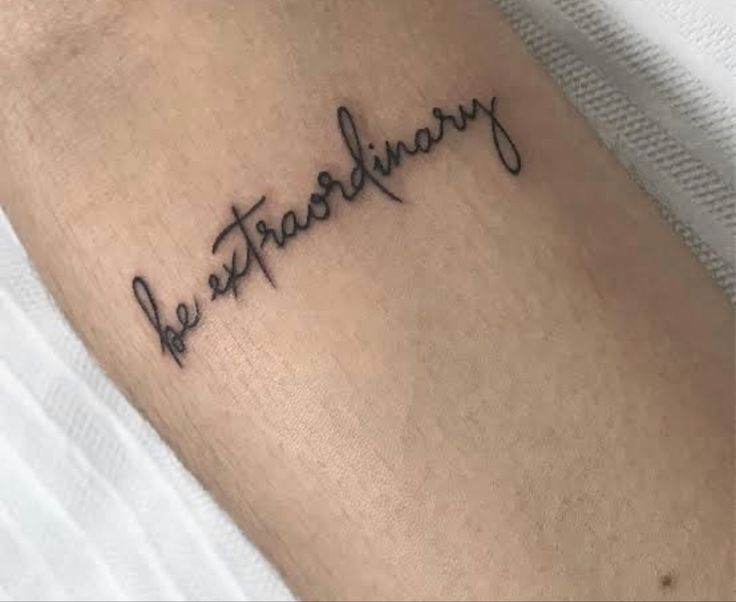 a tattoo that reads be extraordinary on it