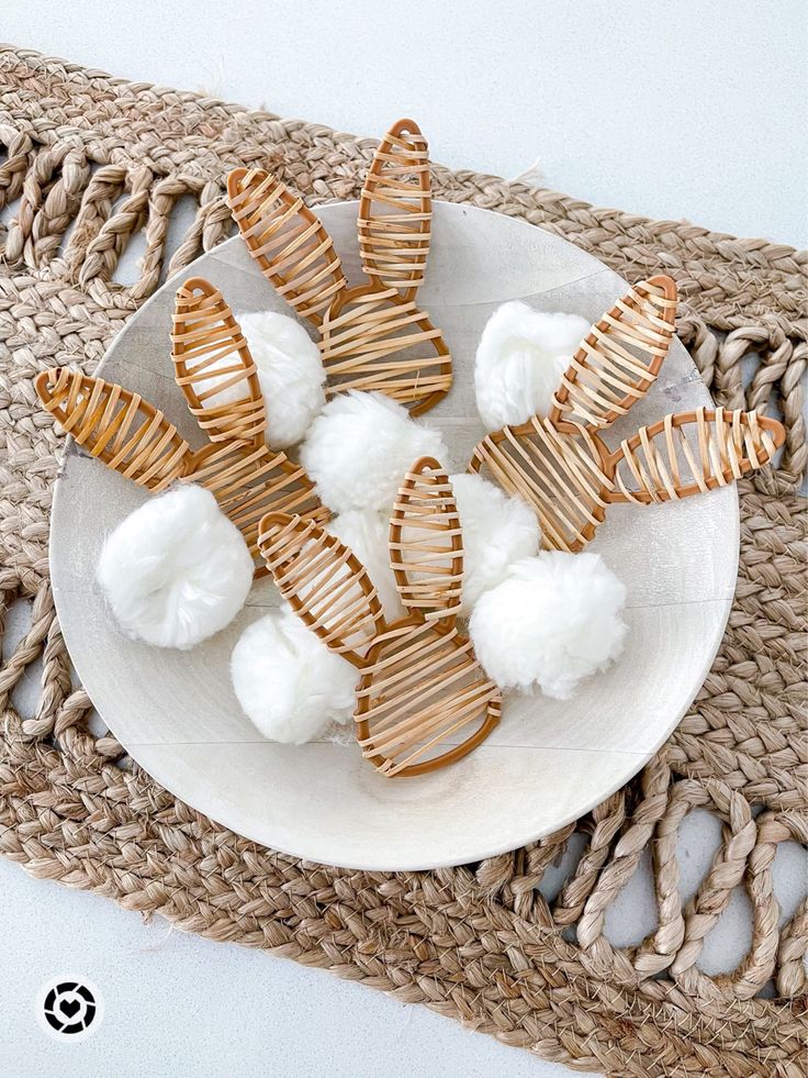 some food is on a white plate and next to a woven placemat with gold trim