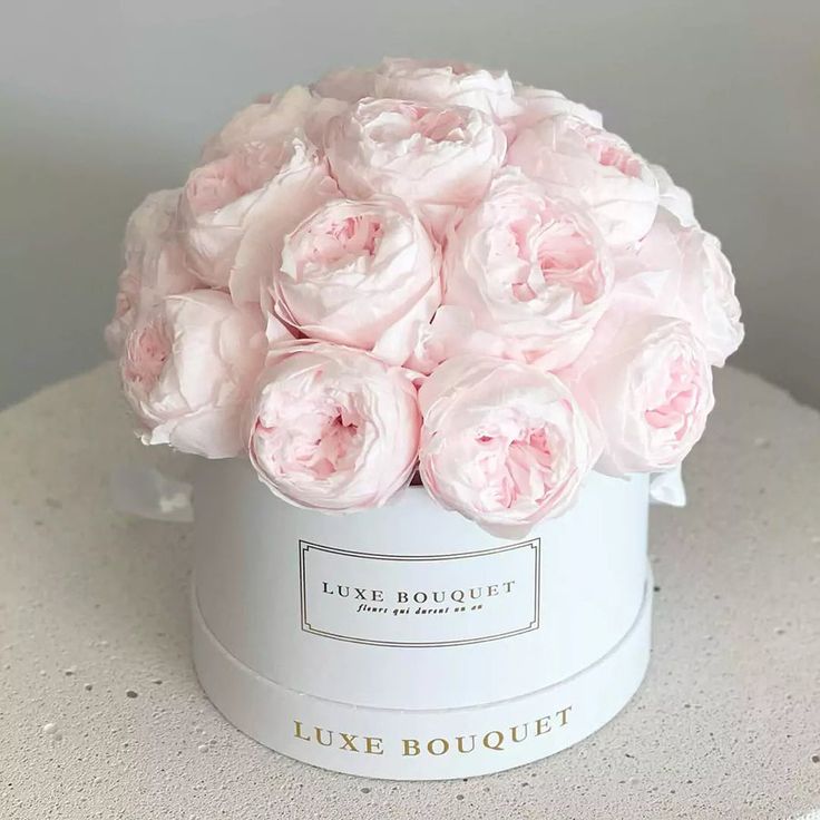 a white box with pink flowers in it