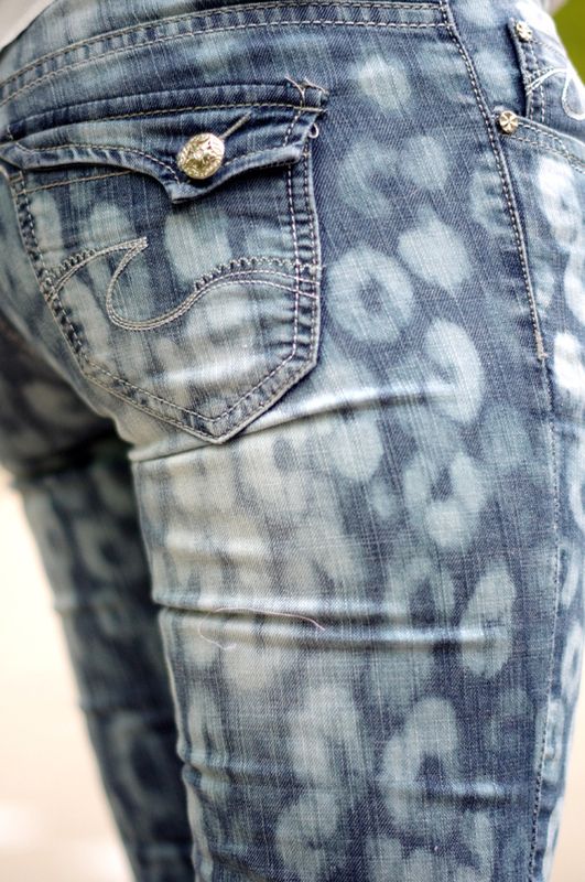 the back view of a woman's jeans with an animal print pattern on it