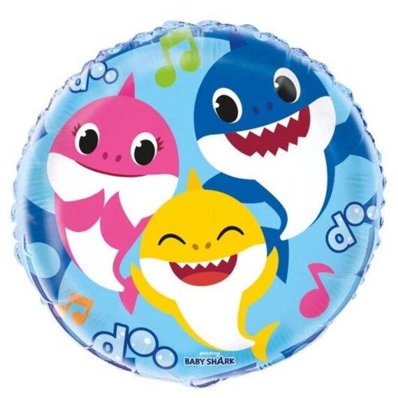 a blue foil balloon with two cartoon shark faces and music notes on the bottom half