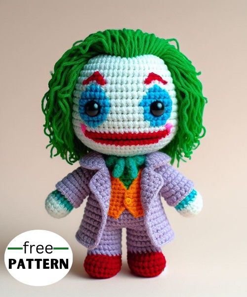 a crocheted joker doll with green hair