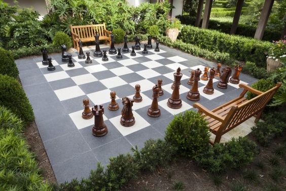 a large chess board set up in the middle of a garden