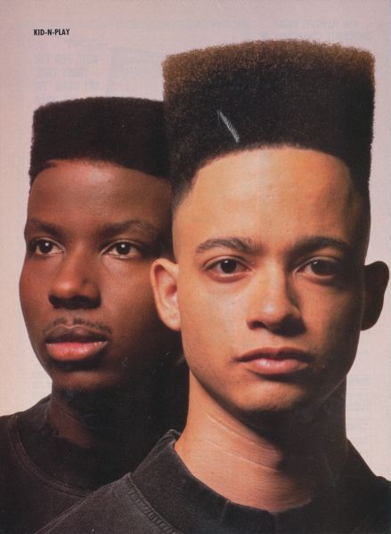 two men with hair combs on their heads and one is looking at the camera