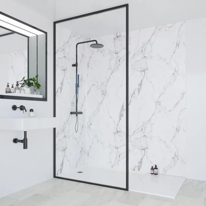 a bathroom with white marble walls and flooring, including a walk - in shower