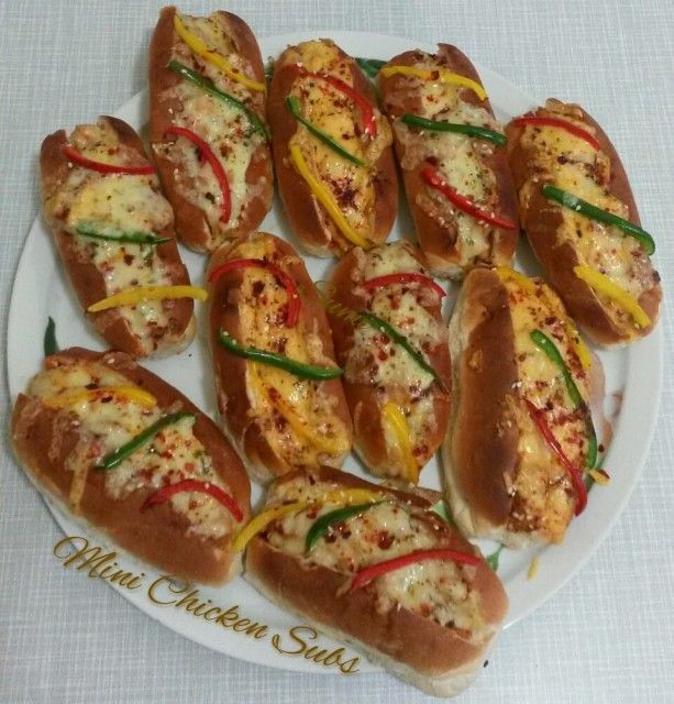 many hot dogs with toppings on a white plate