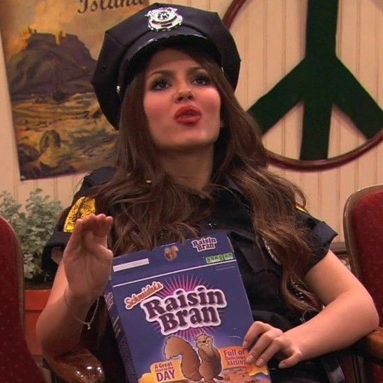 a woman in a police uniform holding up a box of raisin bratin chocolate