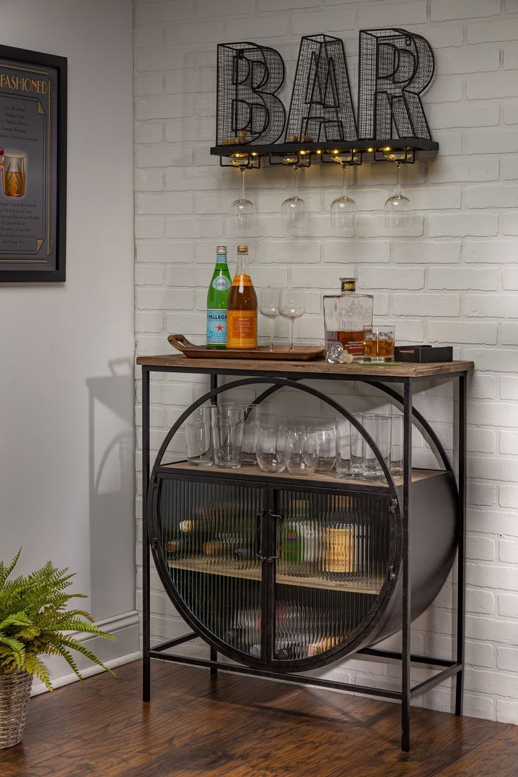 a bar cart with bottles and glasses on it