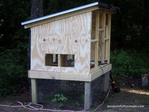 a chicken coop built into the side of a tree