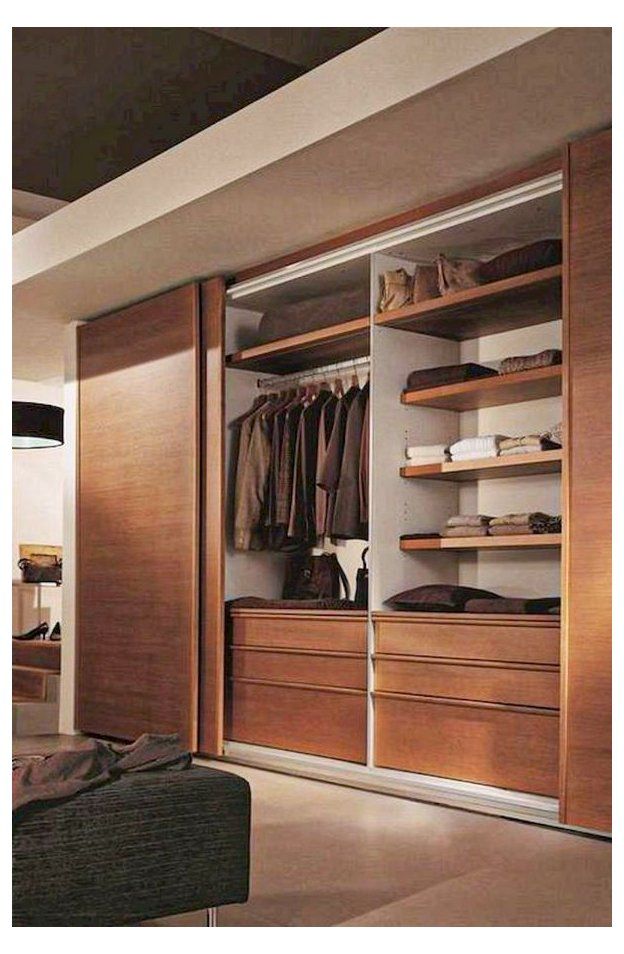 an open closet is shown with clothes and shoes on the shelves in front of it