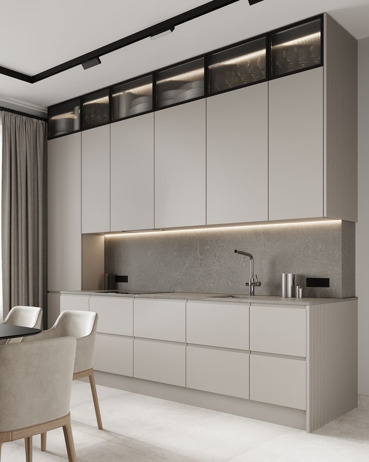 the kitchen is clean and ready to be used for dinner or breakfast time, while the dining table has been set up with white chairs