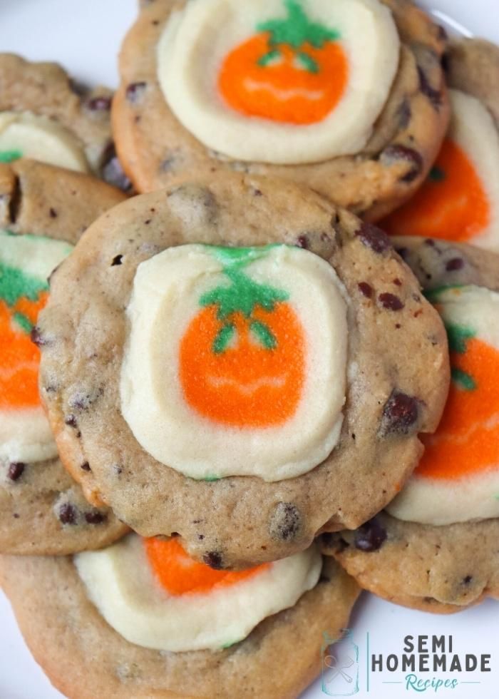 chocolate chip cookies decorated with orange and white frosting