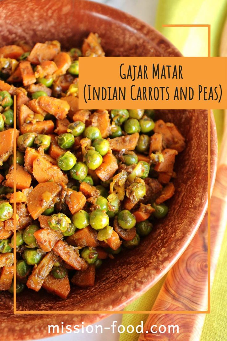 a bowl filled with peas and carrots on top of a table