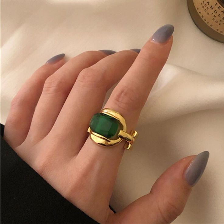 One of a kind, the Marie Green Gem ring is featured with polished 925 sterling silver plated in real 18K gold. It exudes an elegant, vintage retro aurora that will make any style a distinctive statement. Details 18K Gold Plated on 925 Sterling Silver with green stone Size: Open and adjustable Delivered in Poppy Mae custom jewelry boxes ready to be gifted Avoid contact with any chemicals or alcohol. Please refer to our care guide for more details. Chic Rings, Silver Party, Green Stone Rings, Gold Color Ring, Party Rings, Green Gems, Jewelry Model, Stone Gold, Green Gemstones