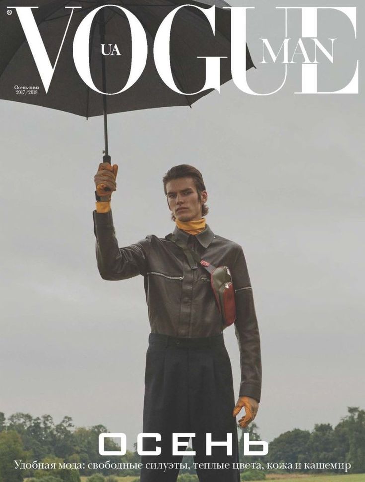 a man holding an umbrella while standing on the cover of a magazine called'back to earth '