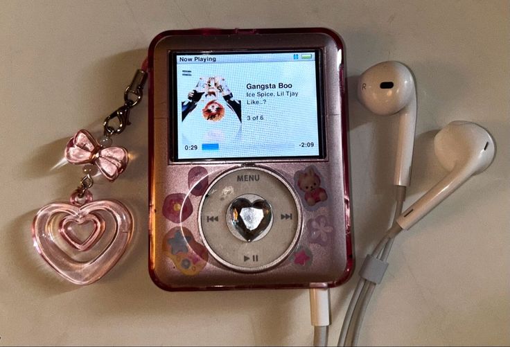 an mp3 player and earphones are laying on the table