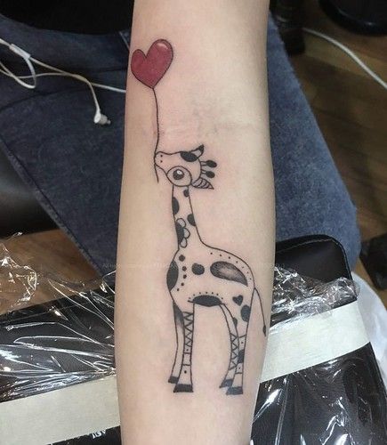 a giraffe with a heart shaped balloon tattoo on the left arm and forearm