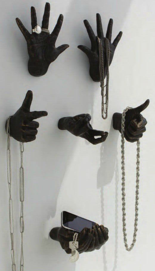 several hands and chains are attached to the wall