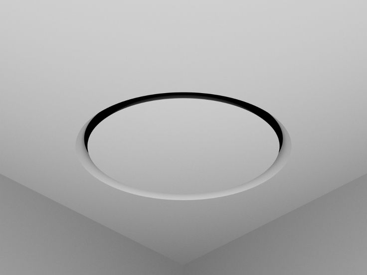 an empty room with a round ceiling light