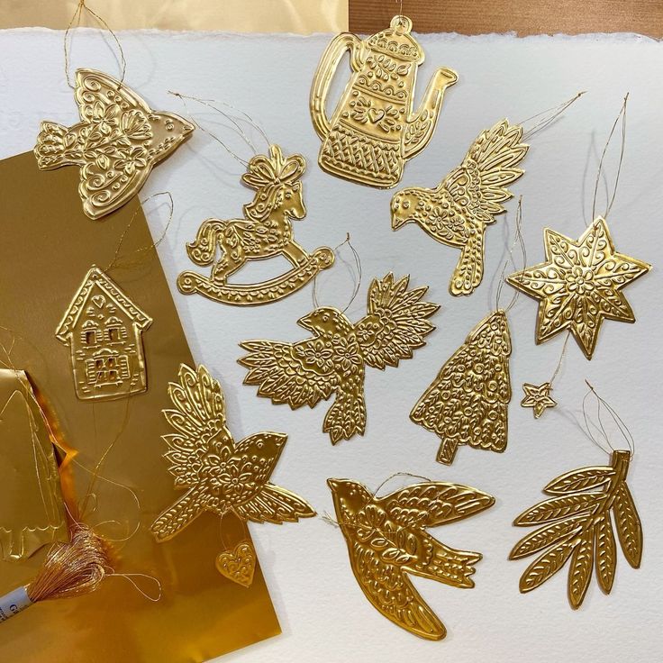 gold christmas decorations are on display next to a piece of paper