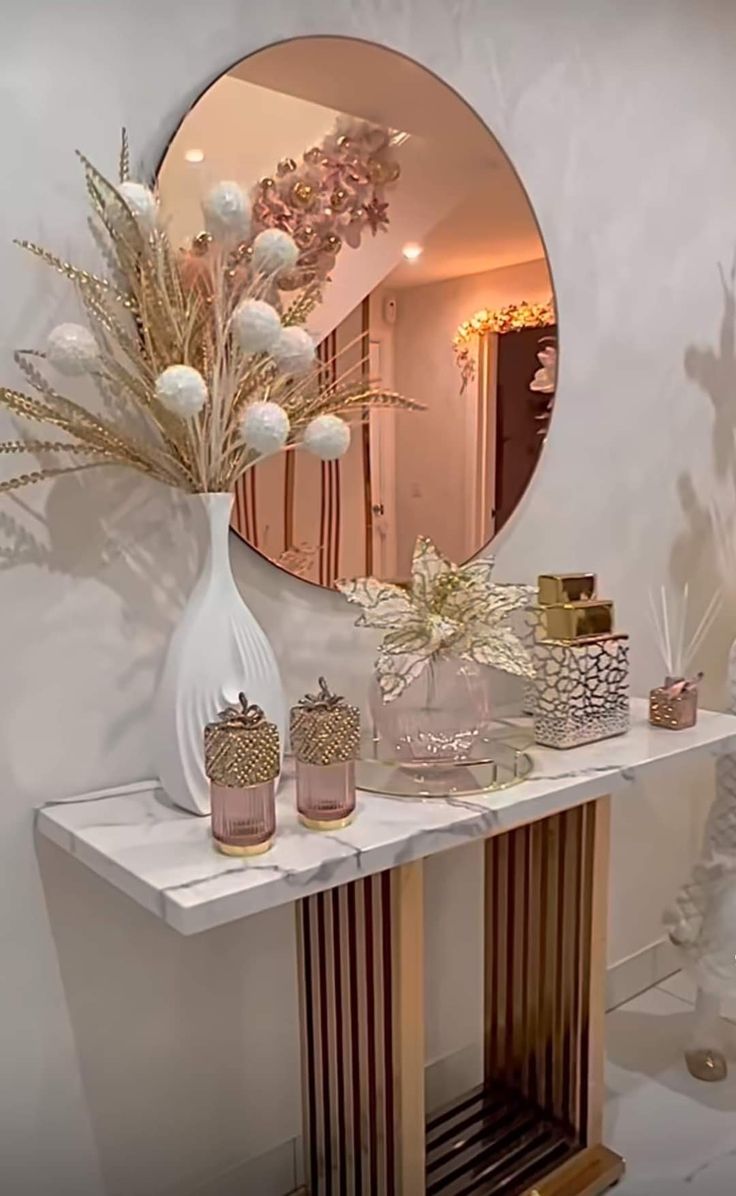 a mirror and some vases on a table