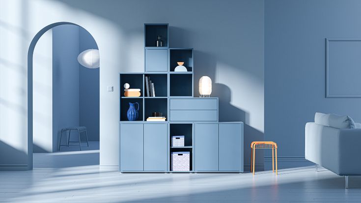 a living room with blue walls and white furniture