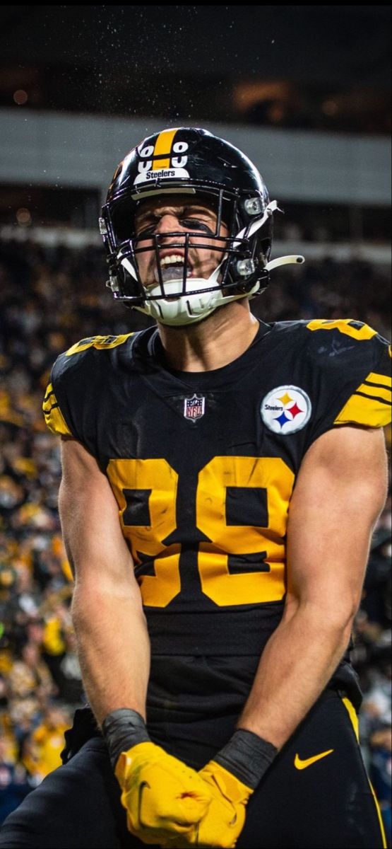 a football player in uniform standing on the field