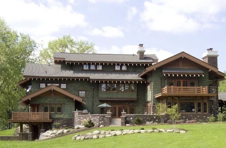 a large house with lots of windows on the front and side of it's roof