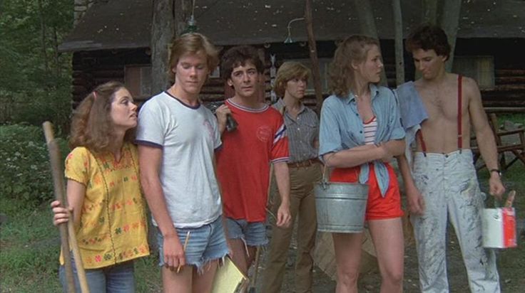 a group of young people standing next to each other in front of a building and holding shovels