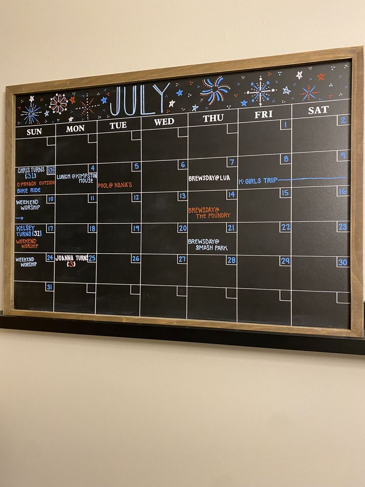 a black and white calendar hanging on the wall