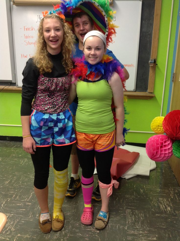 two girls in colorful costumes posing for the camera