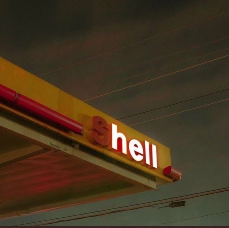 a yellow and red gas station sign with the word hell on it's side