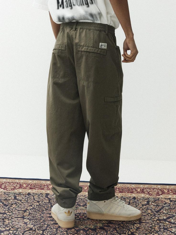 This is a casual and comfortable balloon pants that is made out of sturdy cotton 100% fabric. With soft touch of the fabric, elastic waistband, and hidden pocket, it can be easily styled for your daily outfit.- Washed cotton twill fabric for soft touch- Elastic waistband- Hidden pocket detail Khaki Relaxed Fit Cargo Trousers, Casual Cotton Parachute Pants With Multiple Pockets, Khaki Cotton Cargo Pants, Baggy Cargo Style Cotton Pants, Baggy Cotton Cargo Bottoms, Baggy Cotton Cargo Style Bottoms, Khaki Cotton Parachute Pants With Multiple Pockets, Khaki Cotton Parachute Pants With Pockets, Khaki Parachute Pants With Tapered Leg And Pockets