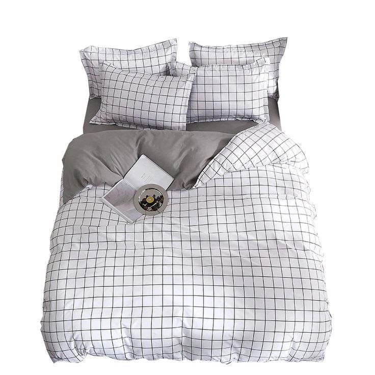 the comforter is made up with grey and white plaid sheets, pillows, and pillowcases