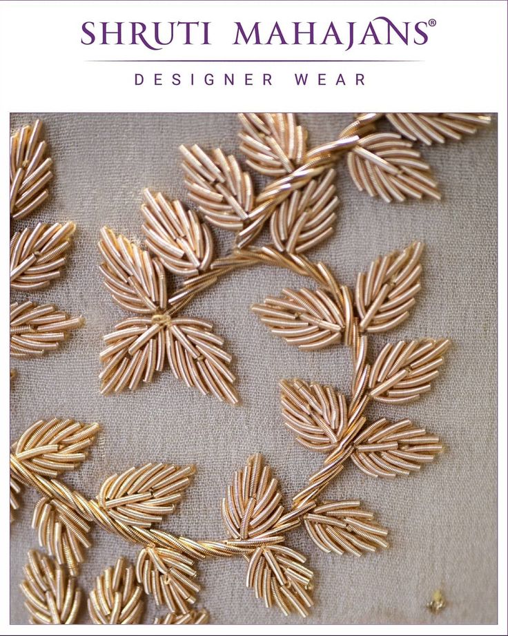 the cover of shriut mahans'designer wear, featuring gold leaves and branches