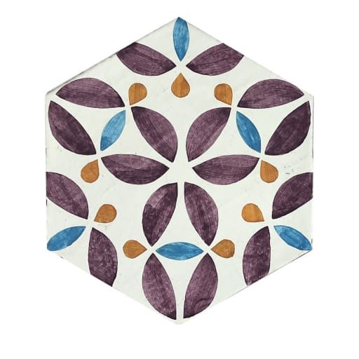 a white and purple hexagonal tile with blue, orange, and brown leaves