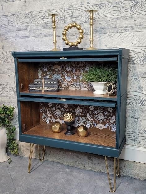 a blue bookcase with some plants on top