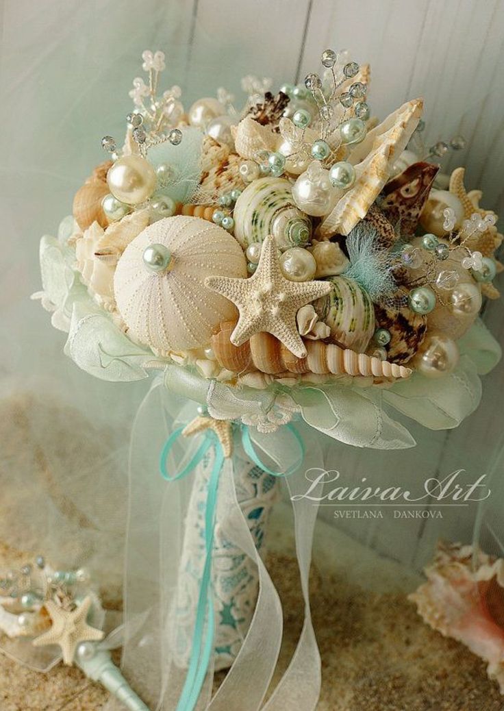 a bridal bouquet with seashells and pearls