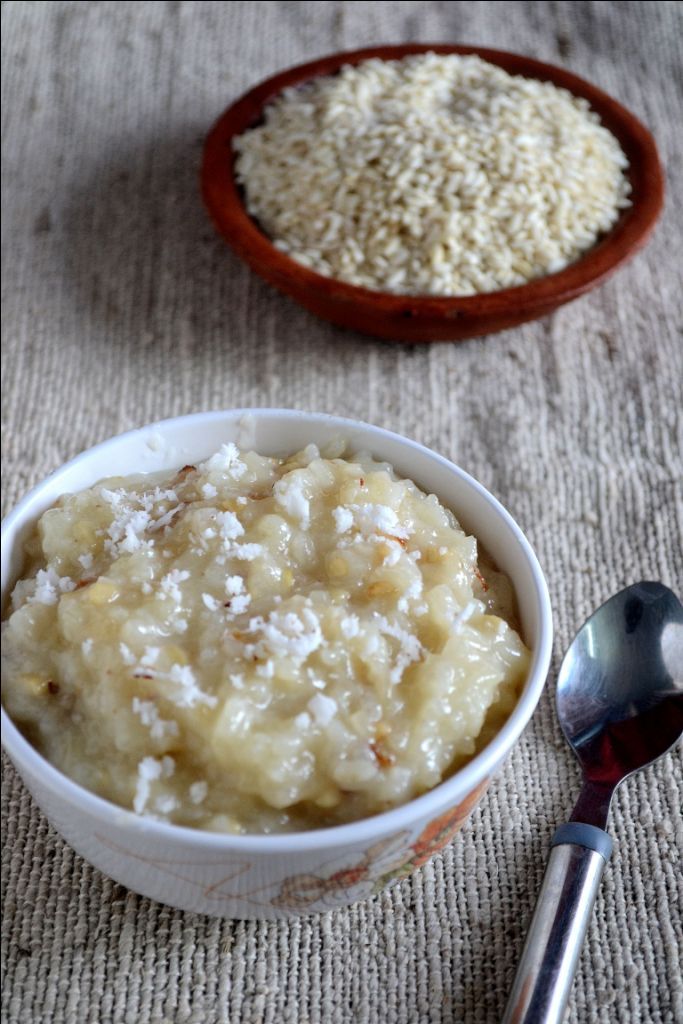 two bowls filled with food sitting on top of a table next to spoons and rice