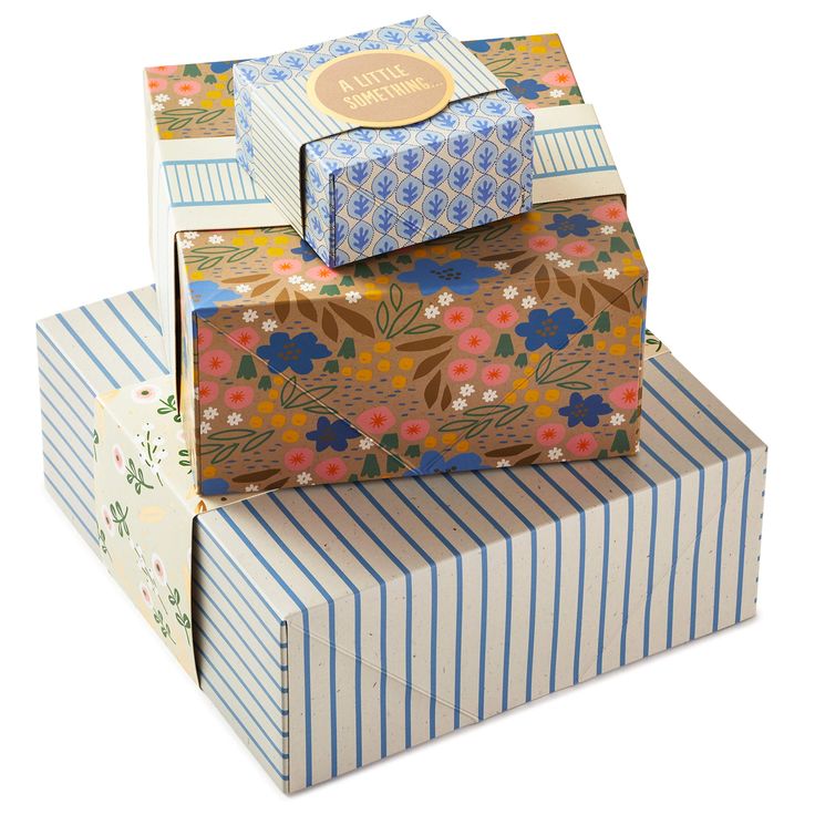 three boxes stacked on top of each other with different designs and colors, one has a flower pattern