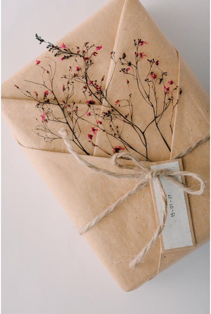 a package wrapped in brown paper and tied with twine on top of each other