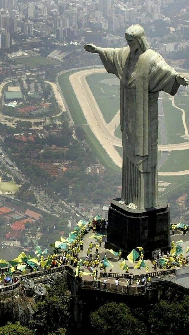 a large statue with many people around it